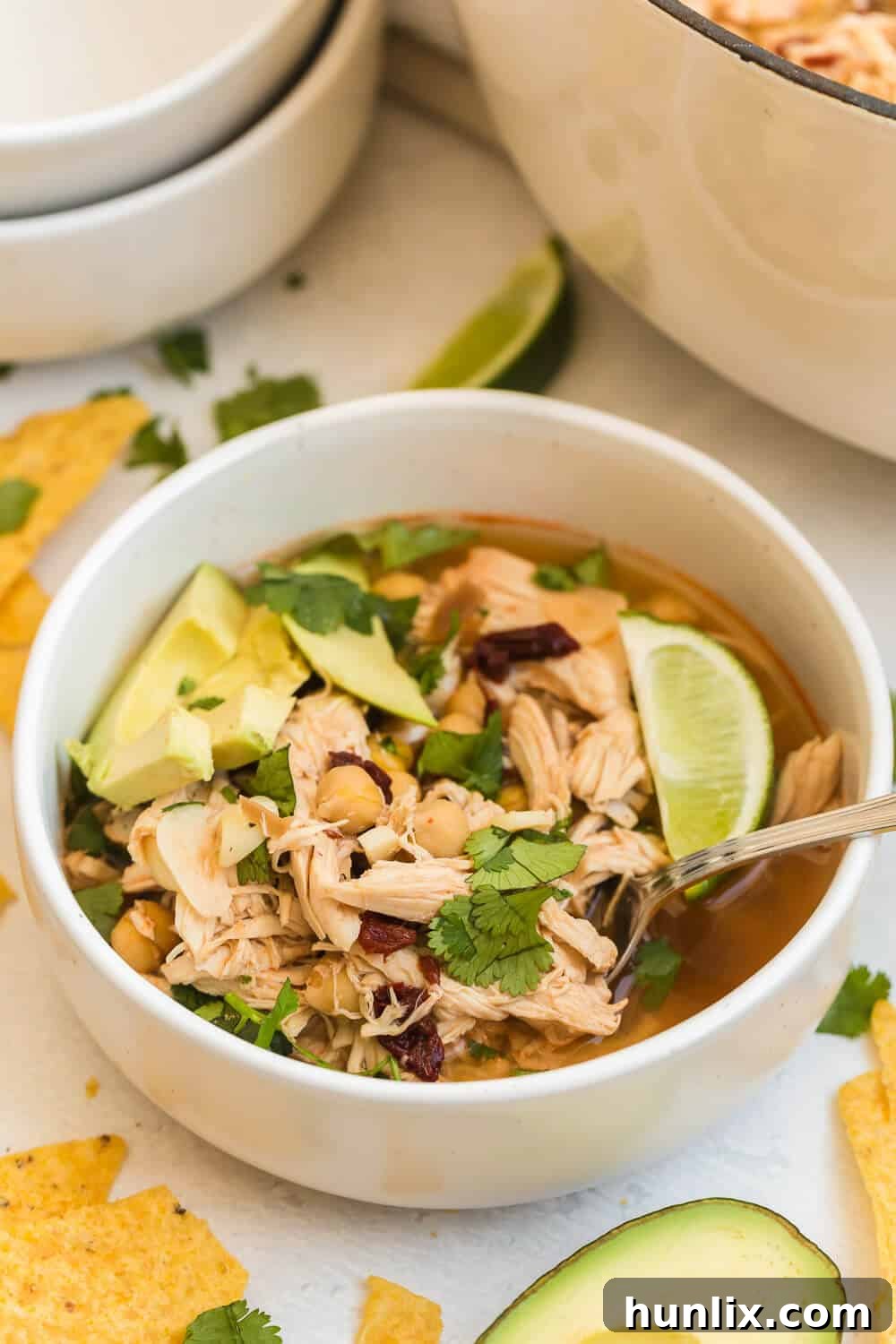 chipotle chicken soup in a bowl with a spoon