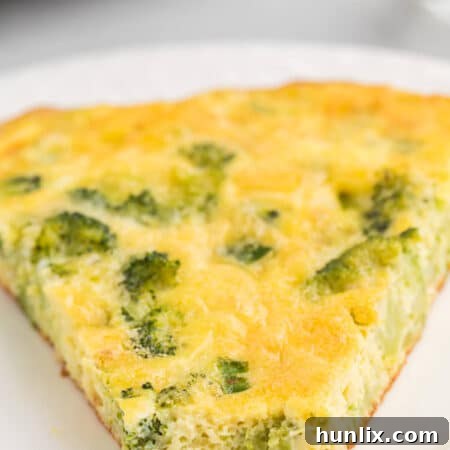 Savory Broccoli Frittata 9 A slice of broccoli frittata on a plate with a bite off the end.