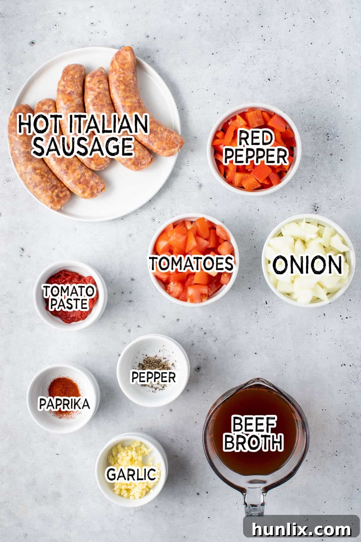 Sizzling Chorizo Stew 3 Various ingredients for spicy sausage soup laid out on a wooden board.