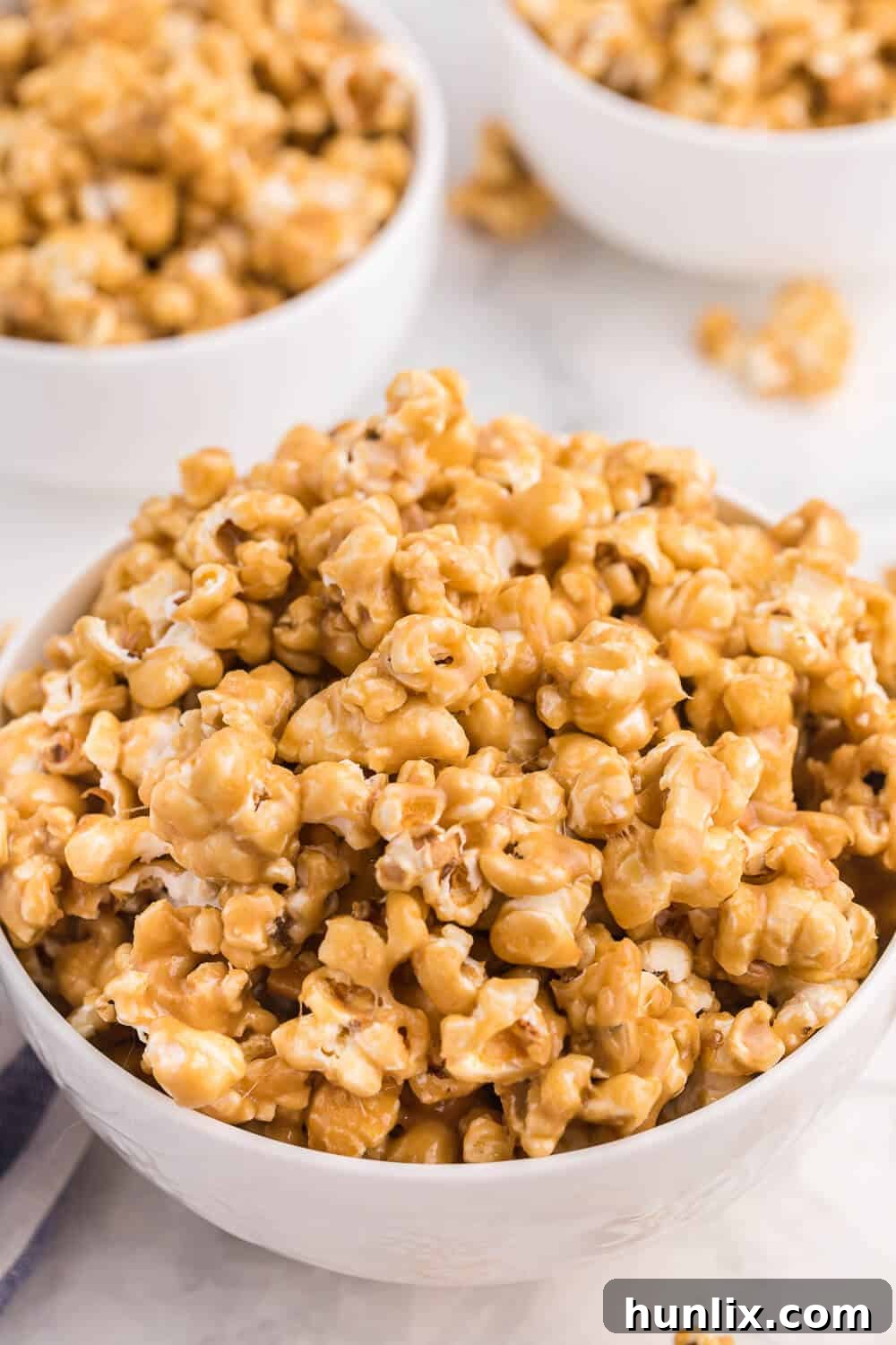 A bowl overflowing with caramel marshmallow popcorn.