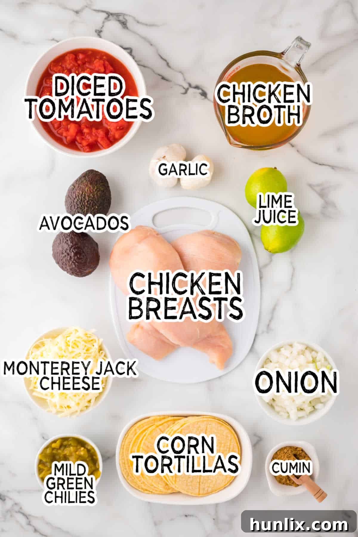 Fiesta Chicken Tortilla Soup 3 A colorful array of ingredients for chicken tortilla soup arranged on a marble counter.