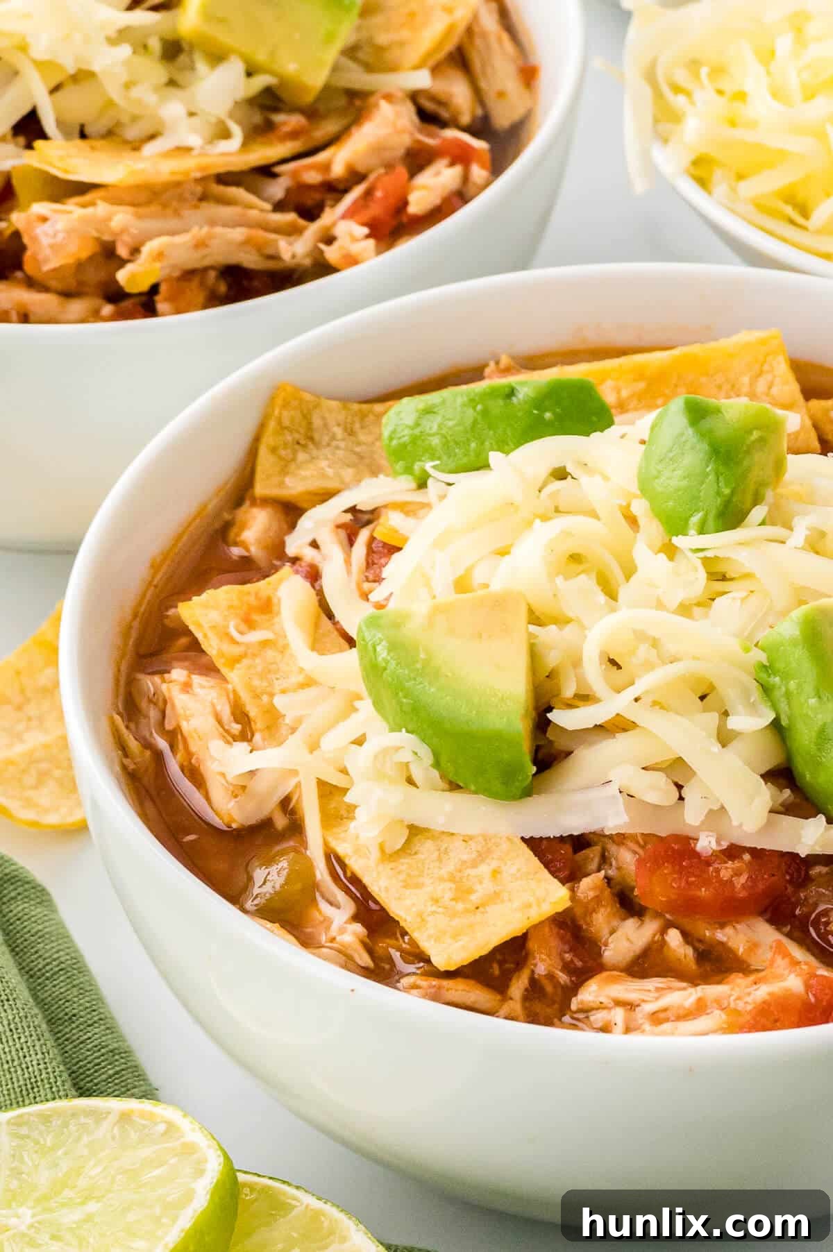 Fiesta Chicken Tortilla Soup 7 A vibrant bowl of chicken tortilla soup loaded with fresh toppings like avocado, cheese, and cilantro.