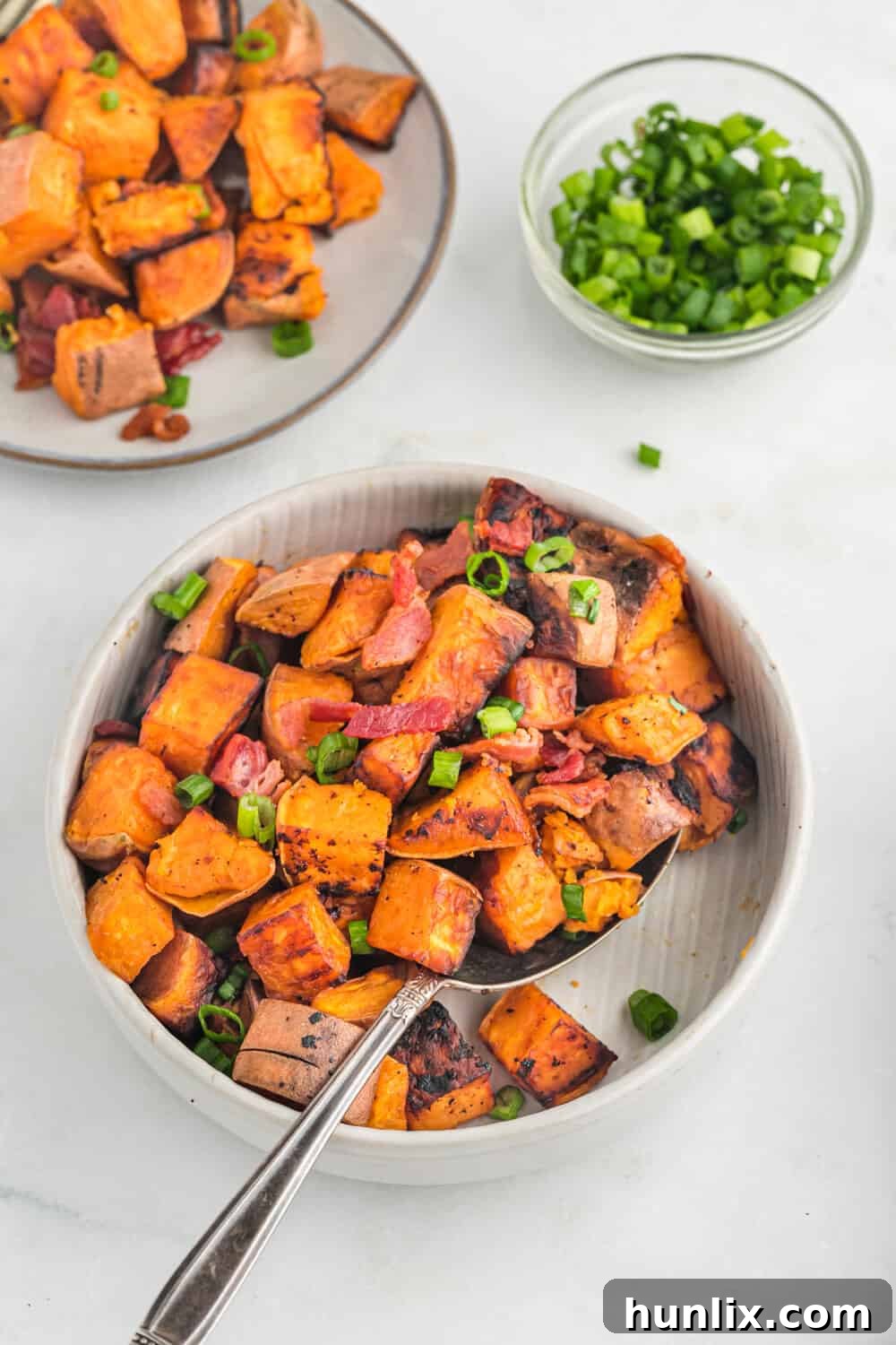 Sweet potato home fries cooking in a pan.