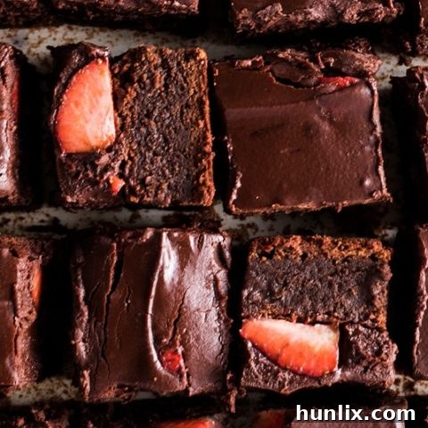 Decadent Chocolate-Covered Strawberry Brownies with fresh strawberries on fudgy chocolate.