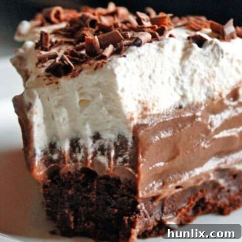 Homemade Chocolate Pudding Pie with a rich brownie crust, a fabulous dessert topped with whipped cream.