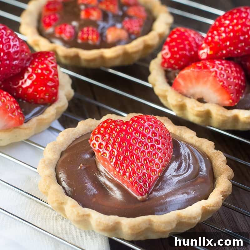Elegant Strawberry & Champagne Truffle Tarts, with rich ganache and champagne-soaked strawberries.