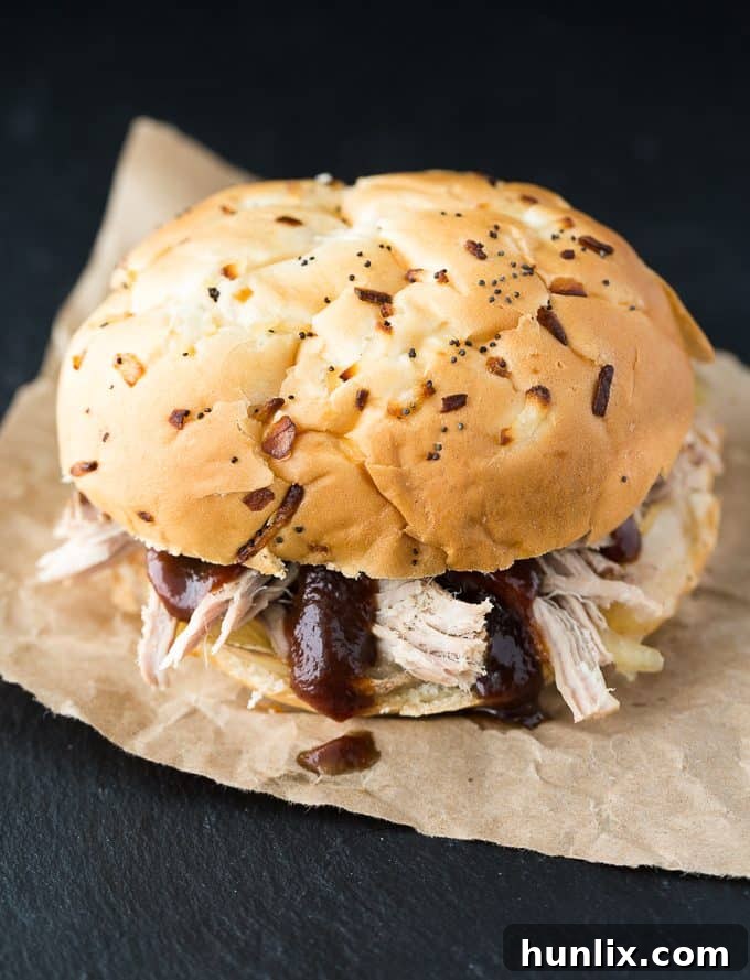 Slow Cooker Pulled Pork - You don't need a smoker for juicy pulled pork! Make this barbecue recipe in the Crockpot for sandwiches, baked potatoes, or pork tacos.