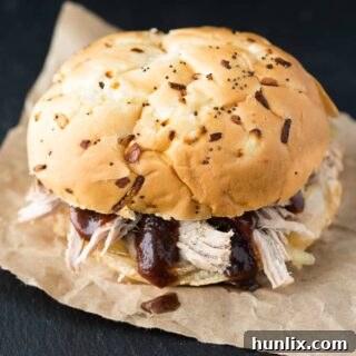 Slow Cooker Pulled Pork - Slow Cooker Pulled Pork - Tender and succulent pork shoulder roast piled high on my favorite sweet rolls. Yum!