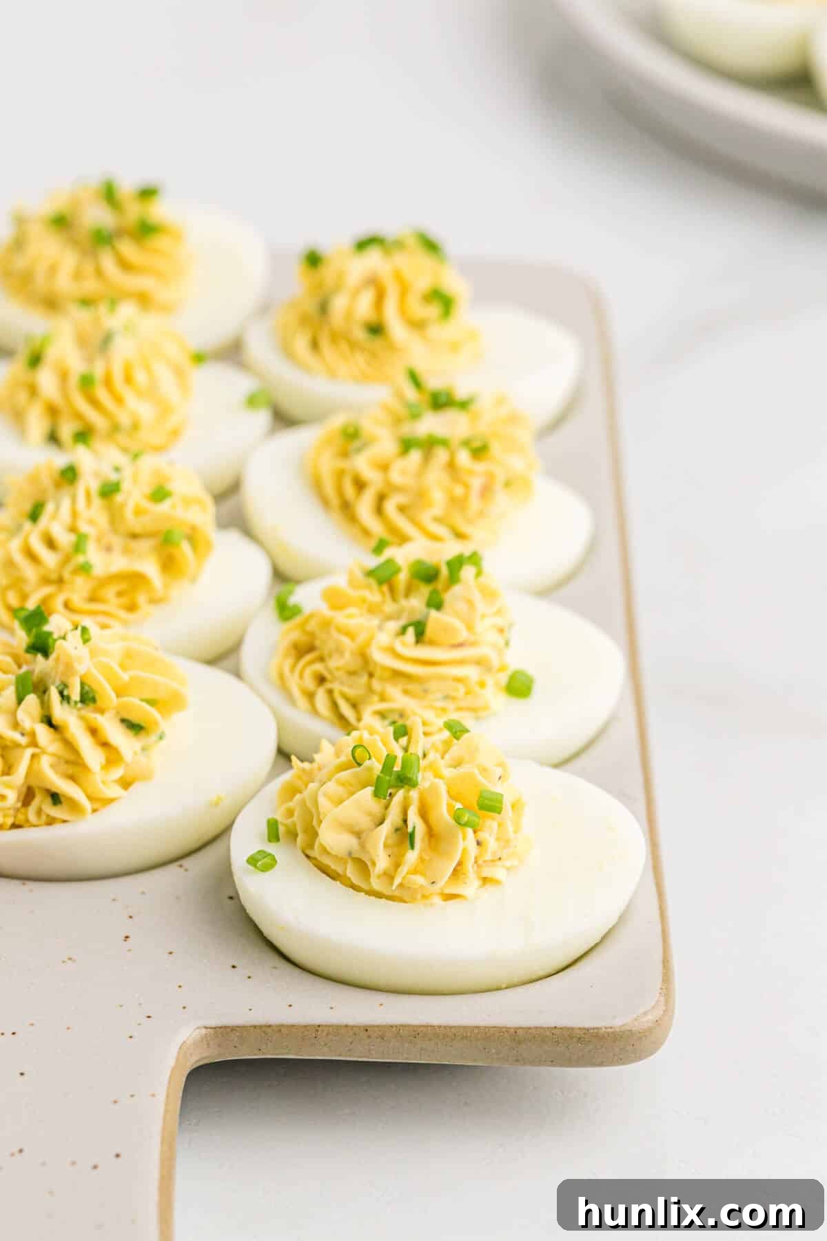 Sinfully Delicious Eggs 7 Another appealing shot of Devilish Eggs, showing a slightly different angle and garnish, reinforcing their delicious appearance.