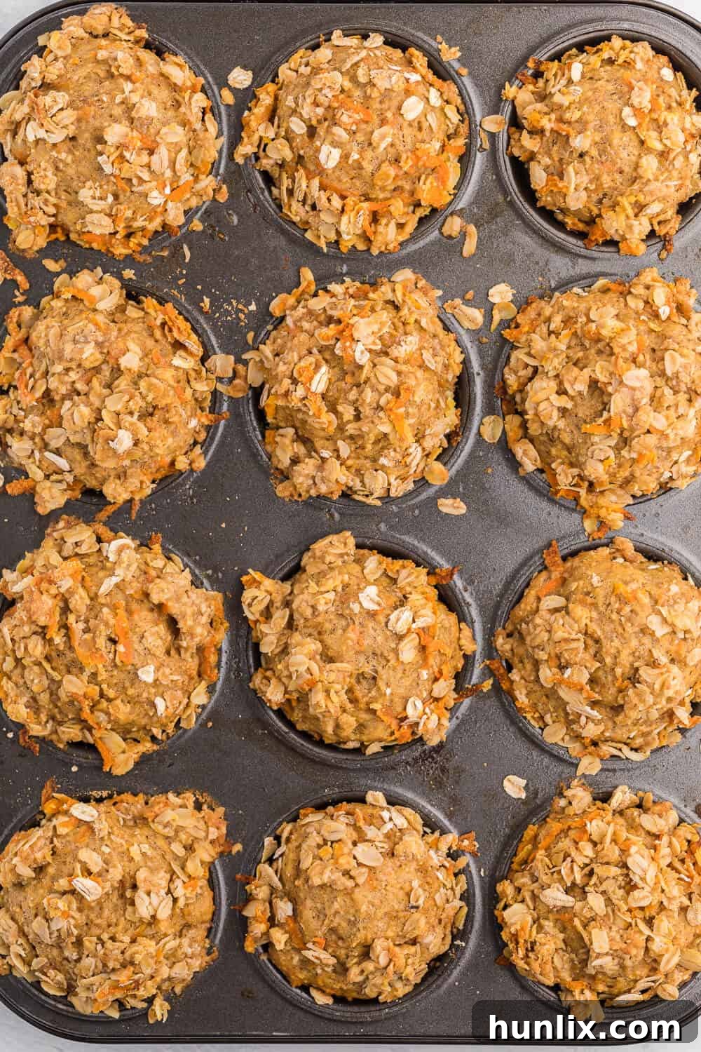Double Orange Muffins - Packed full of goodness with carrots, orange juice, oat bran, flax seed, Greek yogurt and more. Healthy and delicious!