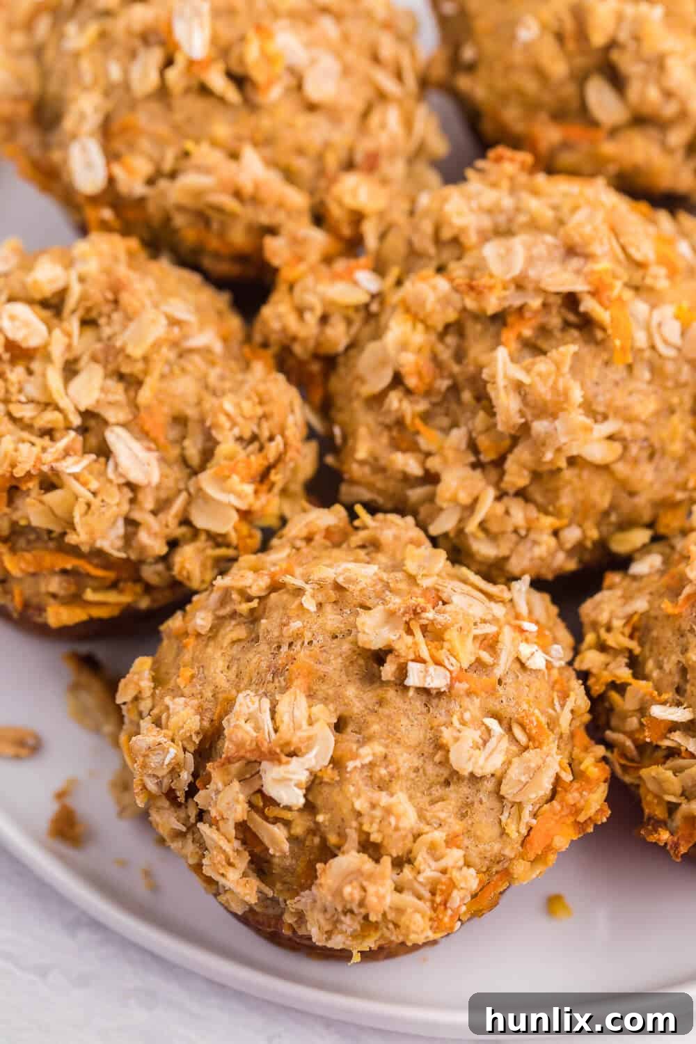Double Orange Muffins - Unbaked muffins topped with streusel, ready for the oven. Highlights the crunchy oat topping and healthy ingredients.