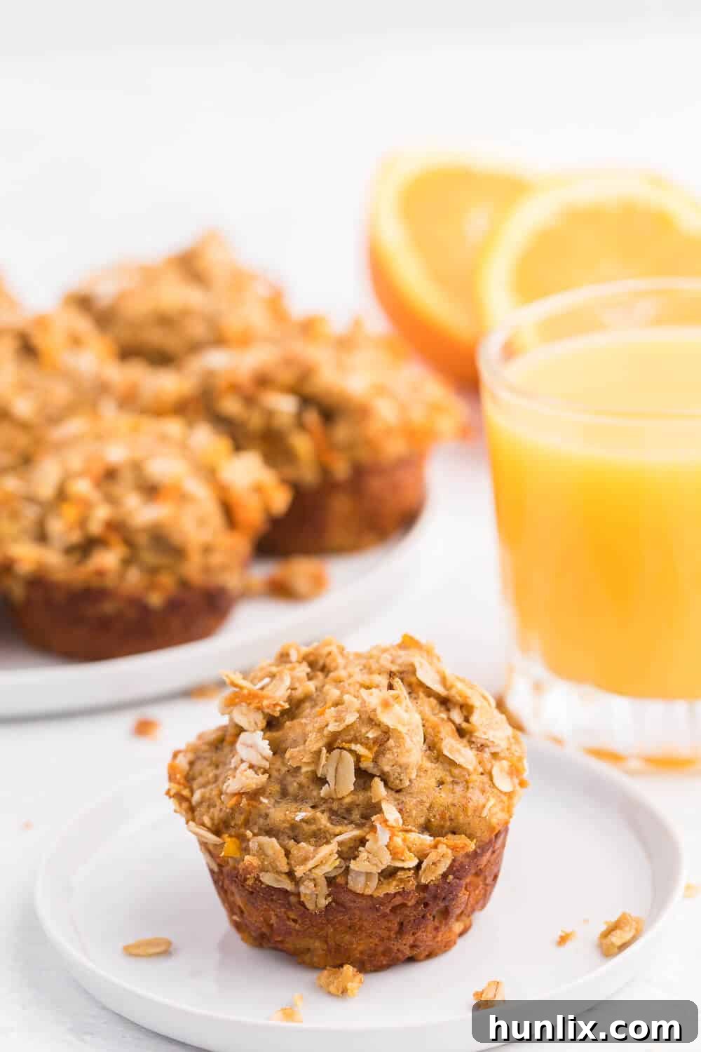 Double Orange Muffins - Freshly baked muffins with streusel topping cooling on a wire rack. Perfect, golden-brown and ready to eat.