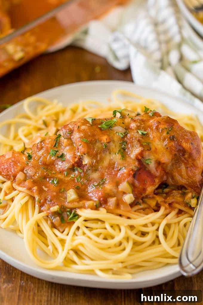 Homestyle Chicken Parmesan Bake 15 A freshly baked Chicken Parmesan ready to be served, garnished with herbs.