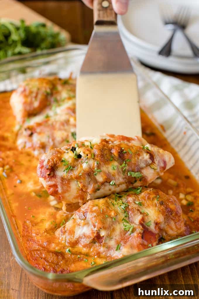 Homestyle Chicken Parmesan Bake 8 Close-up of golden-brown seared chicken breast ready for baking.
