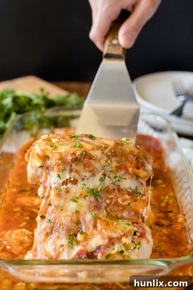 Homestyle Chicken Parmesan Bake 9 A serving of baked chicken parmesan without a breaded crust, highlighting the cheese and sauce.