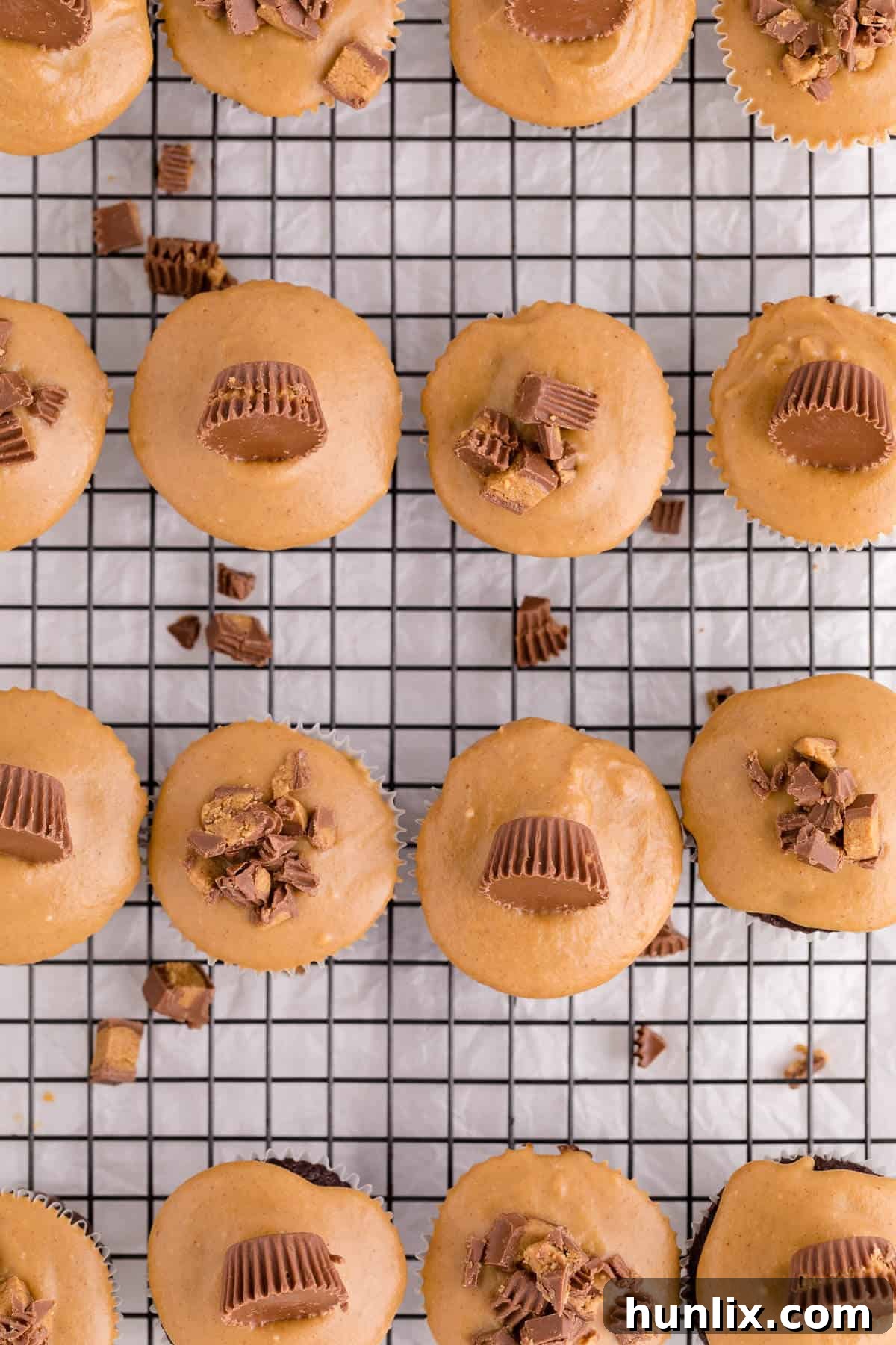Ultimate Reese's Peanut Butter Cupcakes 2 Reese's cupcakes on a wire rack.