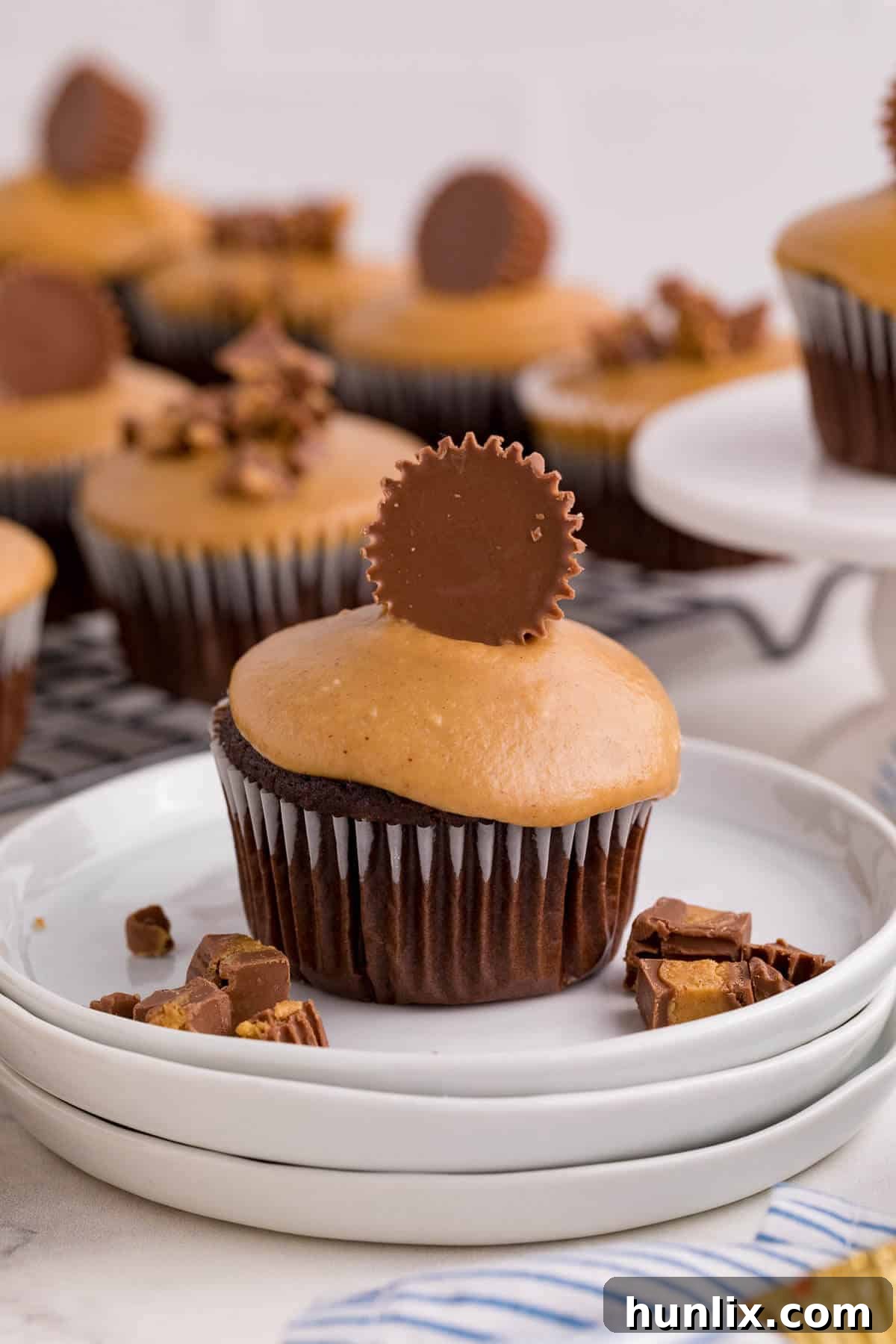 Ultimate Reese's Peanut Butter Cupcakes 5 A Reese's Cupcake on a white plate.