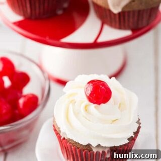 Cherry Coke Cupcakes - Each cupcake has a cherry in the middle, glazed with a Coca-Coca sugar glaze and topped with sweet and fluffy whipped cream.