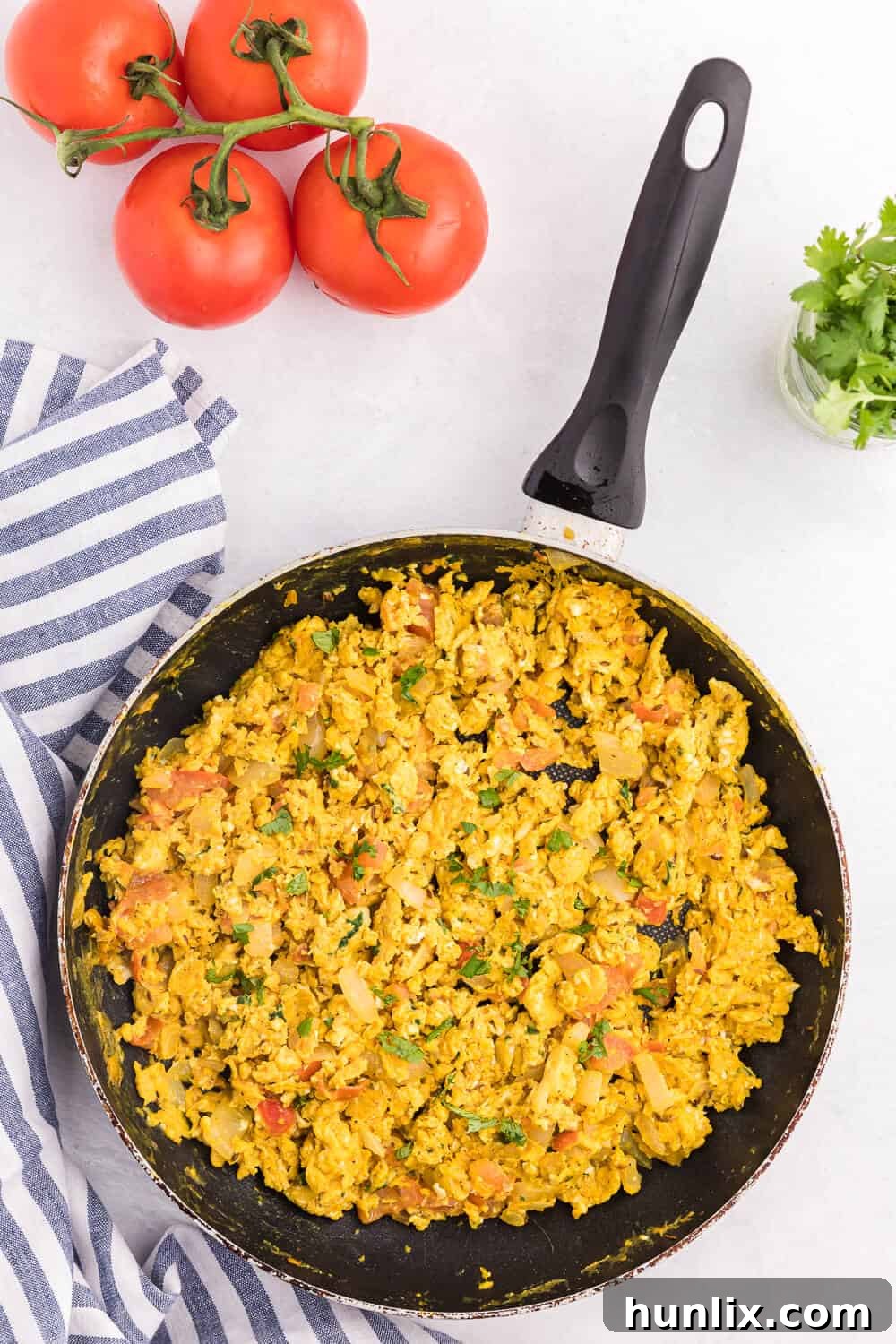 Indian Scrambled Eggs - A vibrant, spicy, and flavorful breakfast dish featuring scrambled eggs cooked with a medley of Indian spices and vegetables like cumin, onion, green chilies, tomatoes, turmeric, and fresh cilantro. Perfect for a quick and satisfying meal.