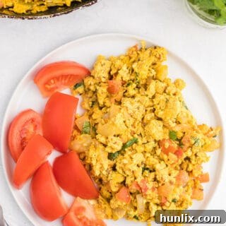 Indian Scrambled Eggs - Bring Indian seasonings to the breakfast table! This quick morning staple is packed with cumin, onion, green chiles, tomatoes, turmeric, and cilantro.