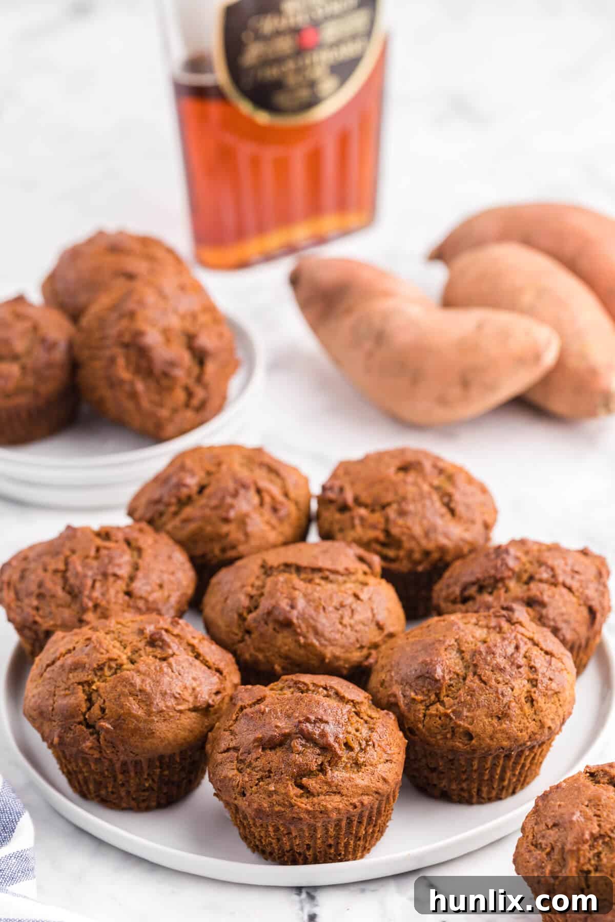 A delightful arrangement of freshly baked sweet potato muffins on a white plate, ready to be enjoyed as a comforting treat.