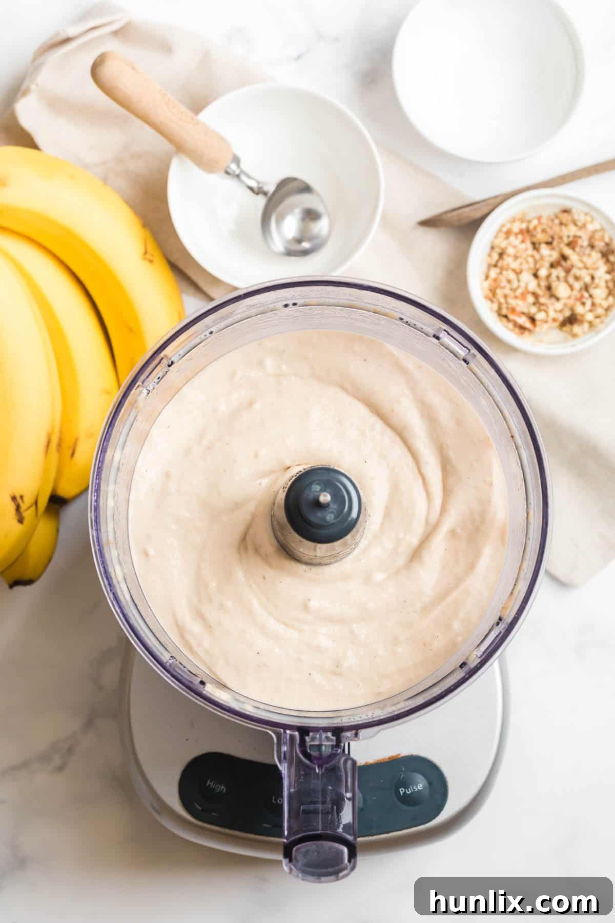 Dairy-free banana ice cream being blended in a food processor