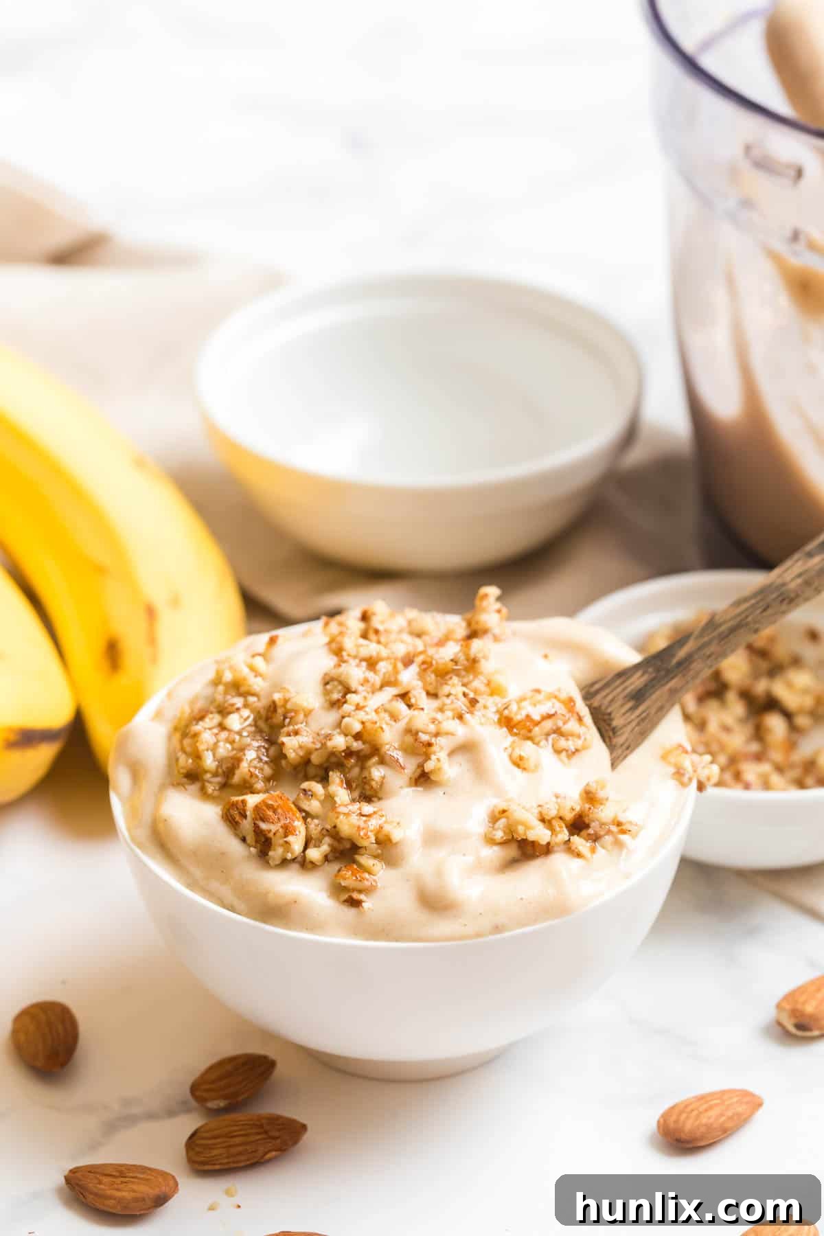 Dairy-free banana ice cream in a bowl with a spoon ready to be enjoyed
