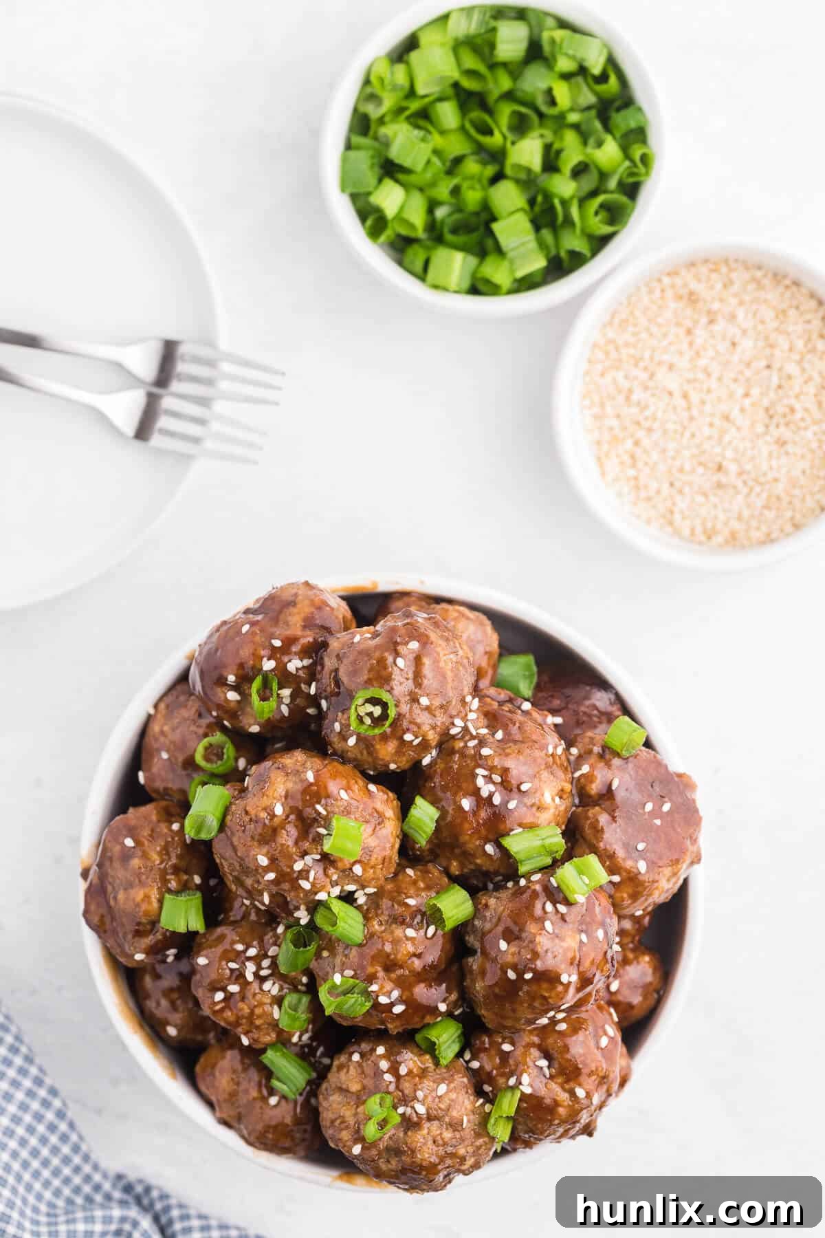 Ginger Meatballs - Add this Asian meatball recipe to your next party menu! Homemade beef meatballs with zesty ginger are smothered in sweet and tangy stir fry sauce. Yum!