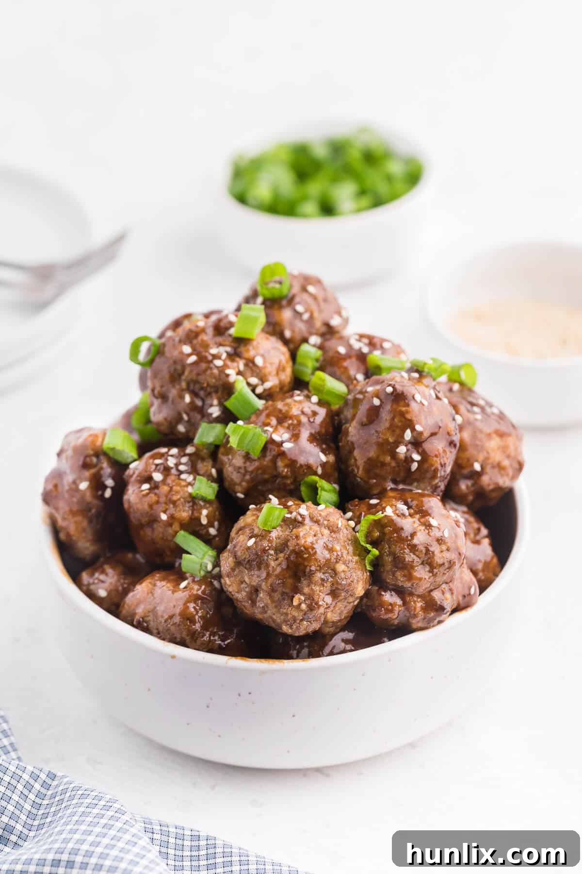 Ginger Meatballs - Add this Asian meatball recipe to your next party menu! Homemade beef meatballs with zesty ginger are smothered in sweet and tangy stir fry sauce. Yum!