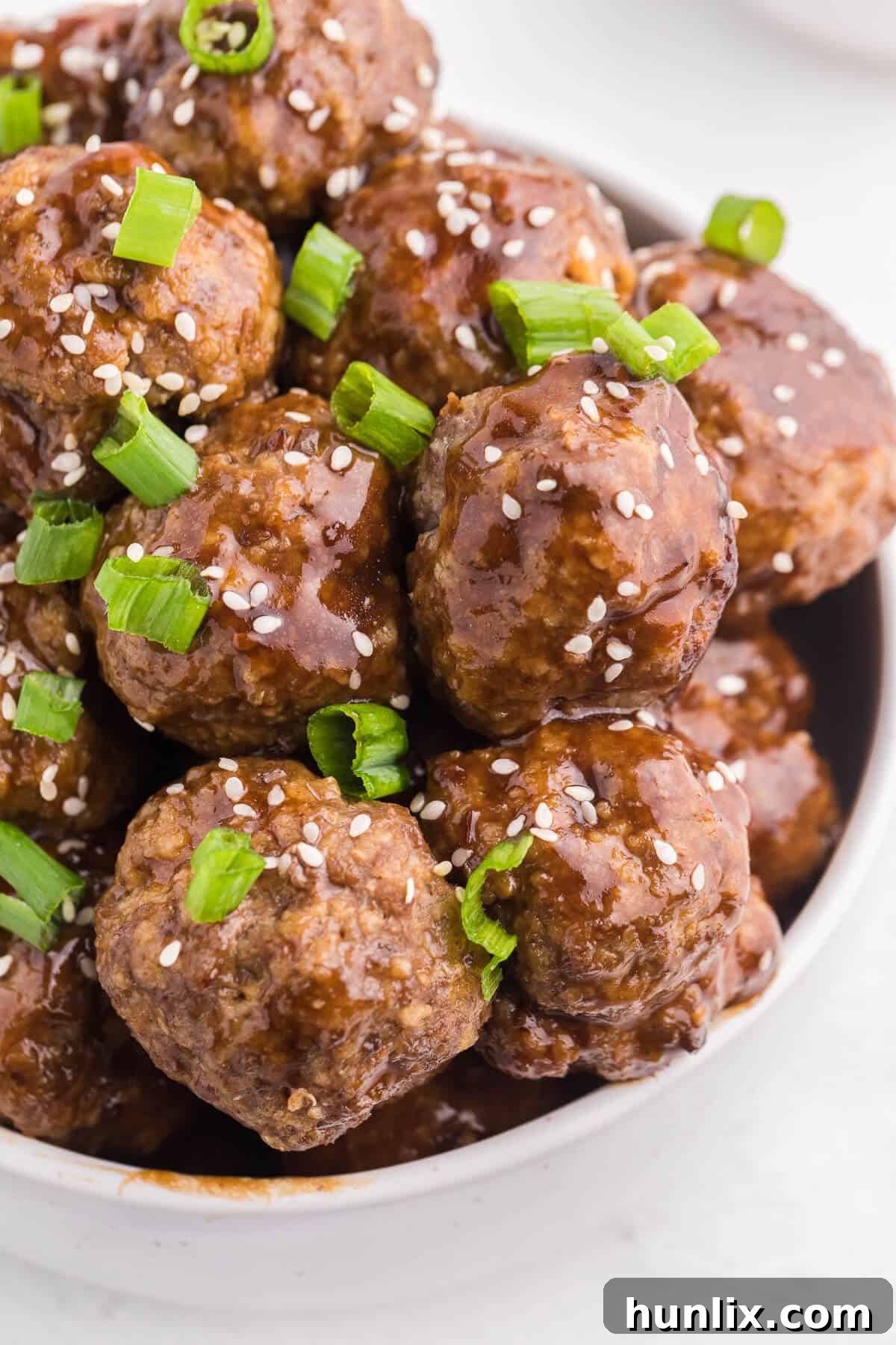 Ginger Meatballs - Add this Asian meatball recipe to your next party menu! Homemade beef meatballs with zesty ginger are smothered in sweet and tangy stir fry sauce. Yum!