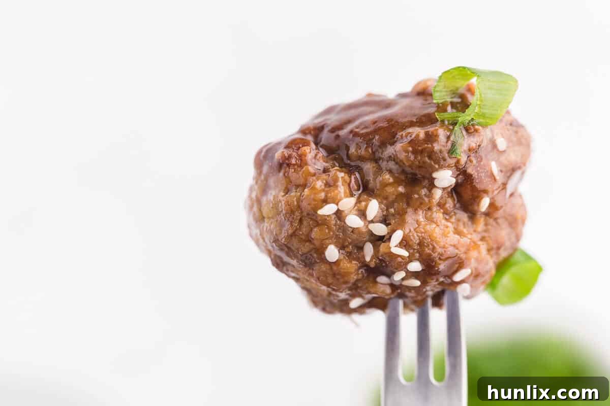 Ginger Meatballs - Add this Asian meatball recipe to your next party menu! Homemade beef meatballs with zesty ginger are smothered in sweet and tangy stir fry sauce. Yum!