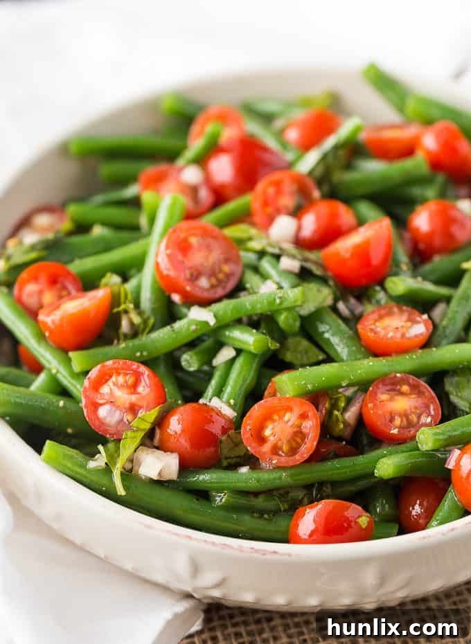 Green Bean and Tomato Salad - A vibrant, easy-to-make side dish perfect for summer BBQs and weeknight meals. Features fresh green beans, ripe tomatoes, and a zesty homemade vinaigrette.