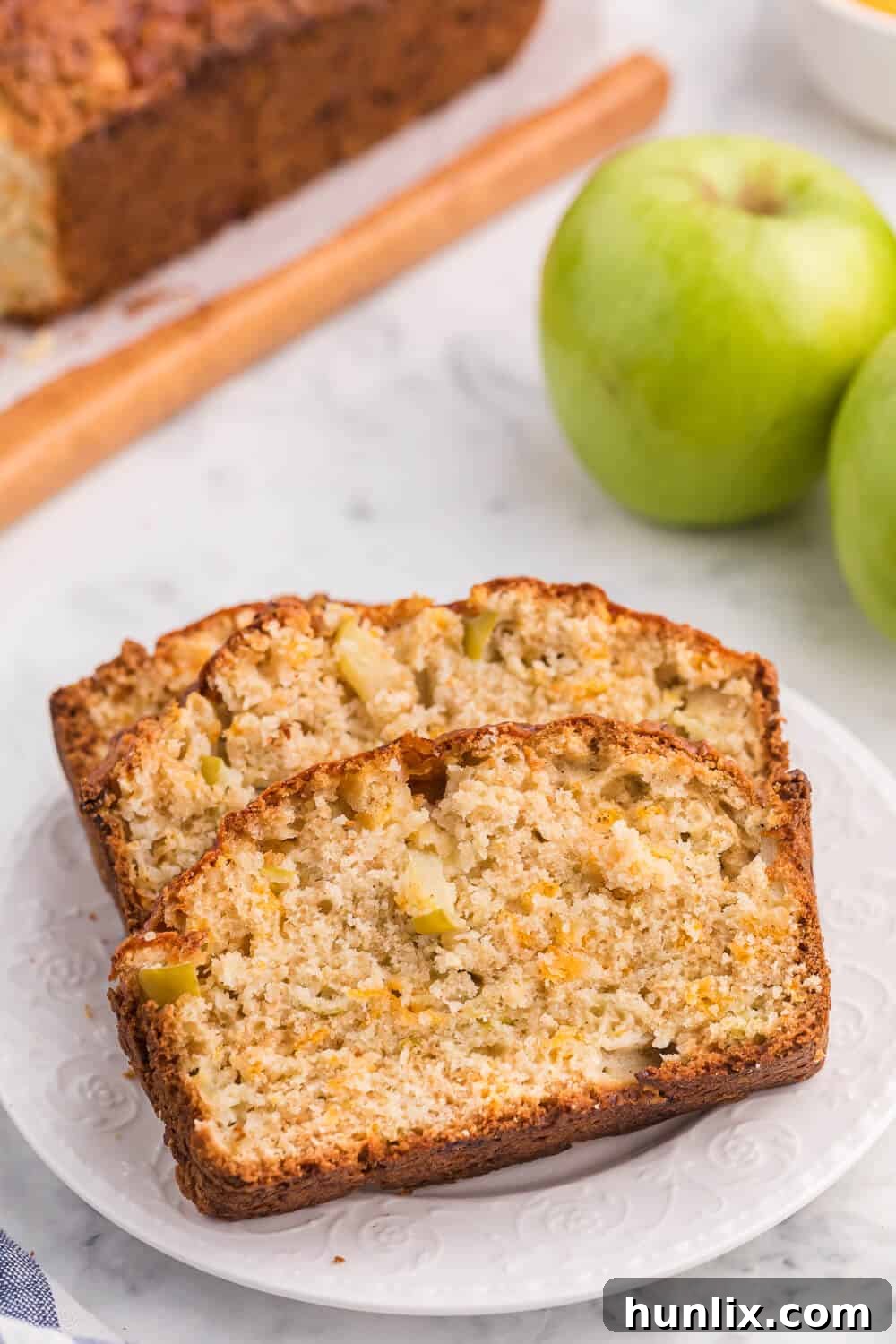 Tangy Cheddar and Sweet Apple Quick Bread 6 Several slices of Apple Cheddar Quick Bread arranged neatly on a white plate, ready for serving.