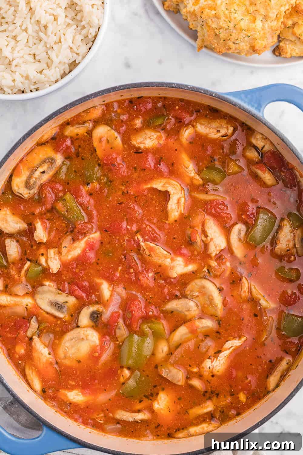 Savory One-Pot Chicken Cacciatore simmering in a Dutch oven, served with fresh herbs.