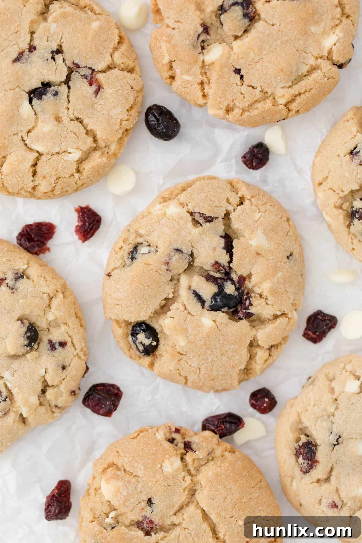 white chocolate chunk cranberry cookies on parchment paper