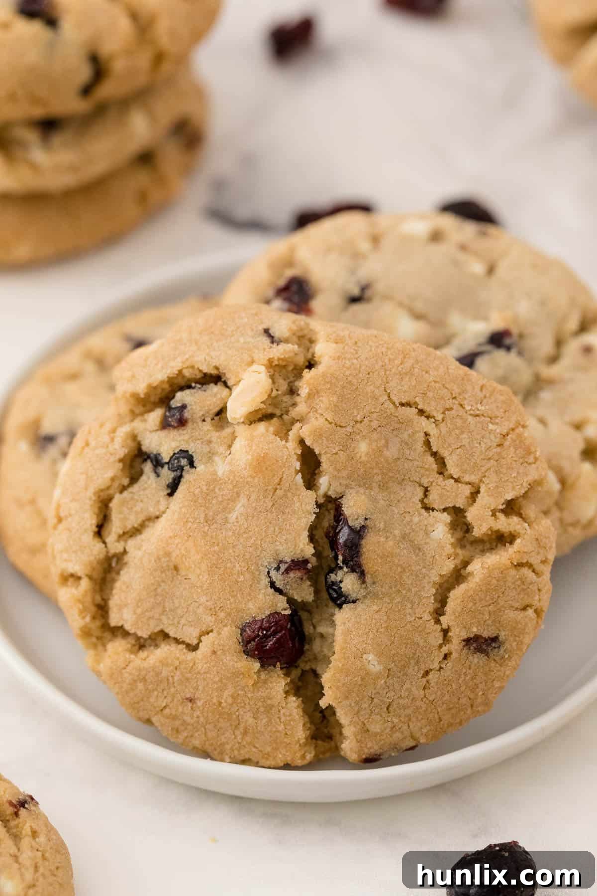 a plate of white chocolate chunk cranberry cookies