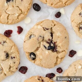 white chocolate chunk cranberry cookies on parchment paper
