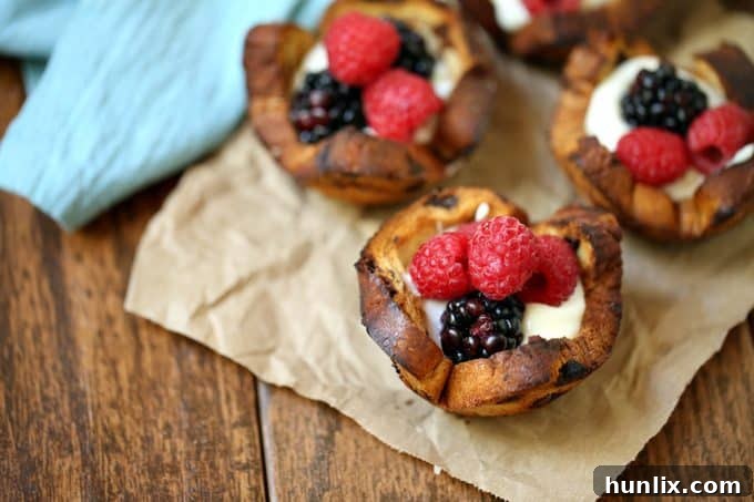 Close-up of a Mixed Berry Breakfast Cup, showcasing the golden brown bread, creamy yogurt, and fresh mixed berries.