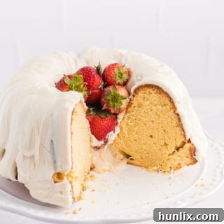 Vanilla Cream Cheese Cake on a cake stand with pieces cut out, serving as the recipe card image.