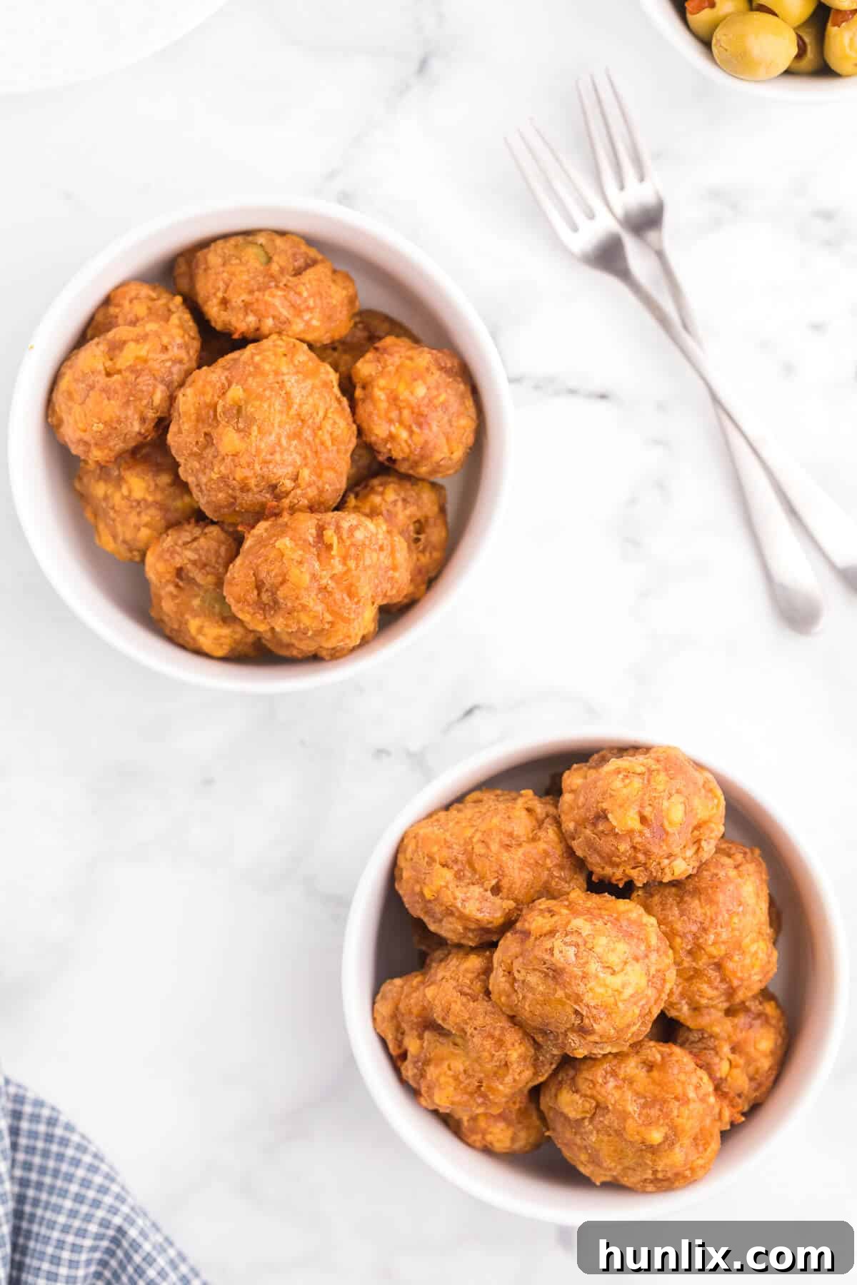 Olive Cheese Balls - A holiday favorite with a vegetarian twist! These perfect hors d'oeuvres are packed with olives, cheese, paprika, Worcestershire sauce, and a pinch of cayenne pepper.