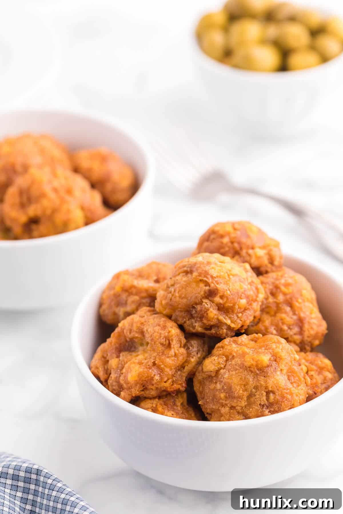 Olive Cheese Balls - A holiday favorite with a vegetarian twist! These perfect hors d'oeuvres are packed with olives, cheese, paprika, Worcestershire sauce, and a pinch of cayenne pepper.