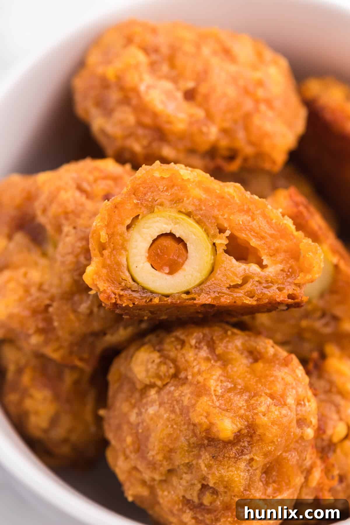 Olive Cheese Balls - A holiday favorite with a vegetarian twist! These perfect hors d'oeuvres are packed with olives, cheese, paprika, Worcestershire sauce, and a pinch of cayenne pepper.