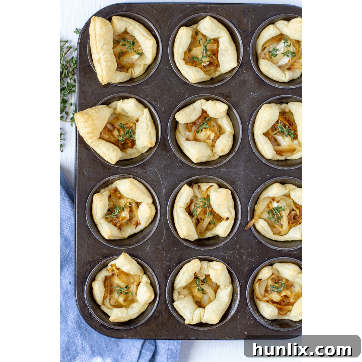 Caramelized Onion and Brie Appetizer Bites - A definite crowd-pleaser with sweet caramelized onions over soft Gruyère cheese on flaky puff pastry, baked to golden perfection.