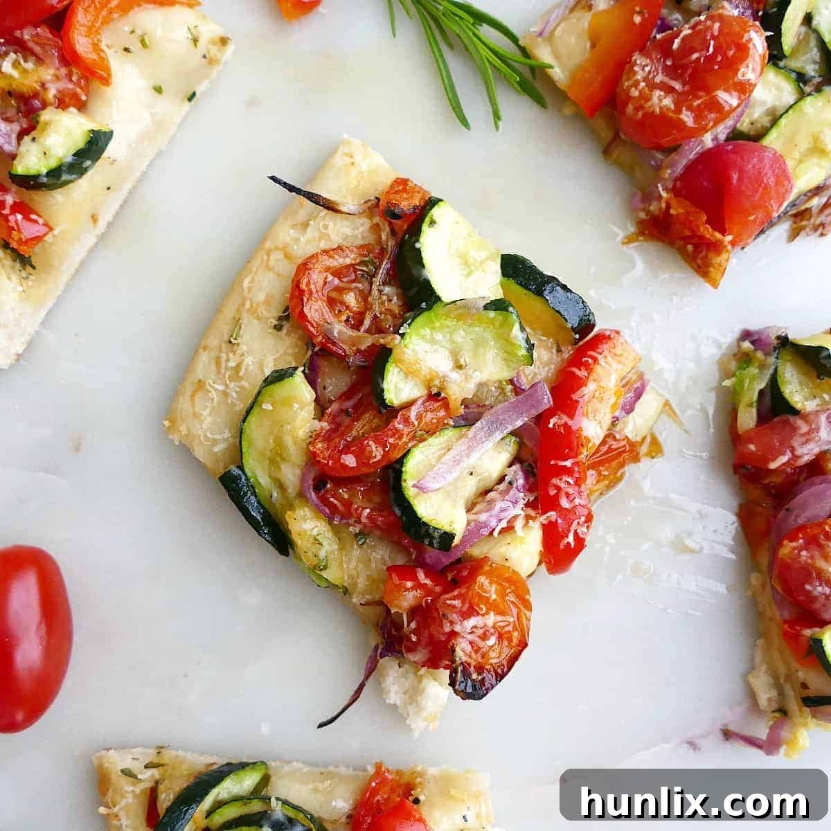Roasted Veggie Flatbread Appetizer - An easy and versatile veggie flatbread recipe that makes a great appetizer or snack for a party. Can be sliced and served warm or cold.