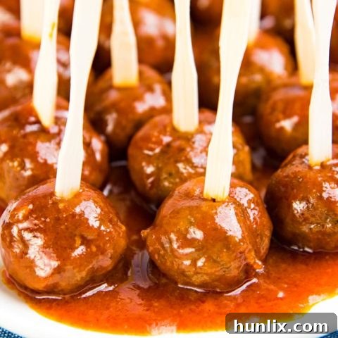 Delicious Cocktail Meatballs - Tender, juicy, and flavorful homemade meatballs made with ground beef and pork, coated in a sweet and spicy honey, orange juice, and sriracha sauce.