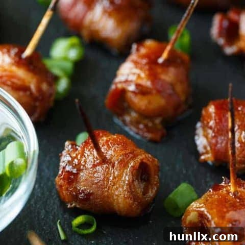 Bacon-Wrapped Water Chestnuts - An incredibly popular and easy appetizer. Whole water chestnuts are wrapped in crispy bacon and marinated in a delightful sweet and savory sauce, perfect for any party.