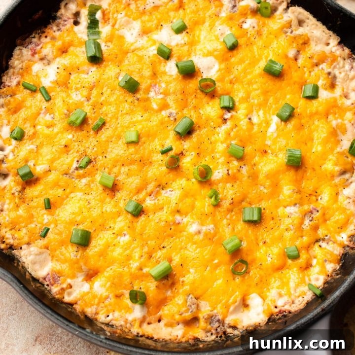Cheesy Rotel Sausage Dip - A flavorful sausage dip recipe with pork sausage, Rotel tomatoes, cream cheese, and cheddar. Great for game day or as a party appetizer.