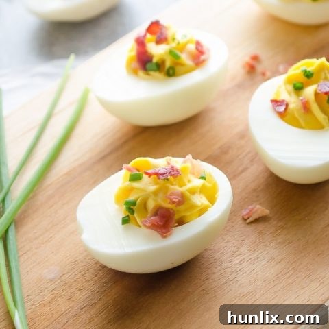 Bacon Deviled Eggs - Creamy and delicious deviled eggs topped with crispy bacon and fresh chives. A huge crowd-pleaser perfect for entertaining.