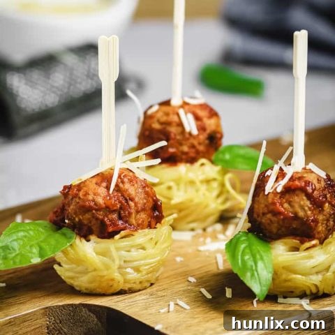 Mini Spaghetti Nests and Italian Meatballs Appetizer - Perfectly satisfying little bites made with creamy Alfredo pasta and flavorful Italian-style meatballs.