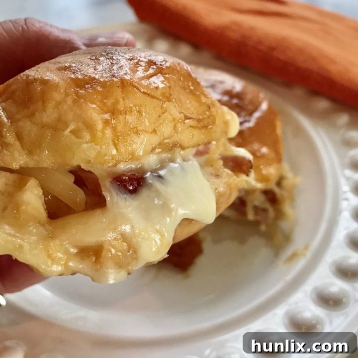 Hammy Sammies {Hawaiian Roll Ham and Swiss Sliders} - Delicious ham and cheese sliders made with Hawaiian King Rolls and a to-die-for sauce. Easy to make ahead and serve warm or cold.